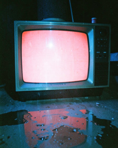 Une vieille télévision allumée dans le noir